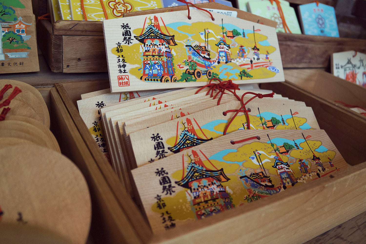 Wooden talismans for good fortune for sale at a stall in a temple during a Cherry Blossom Festival in the Gion area of Kyoto Japan.